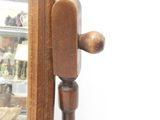 a mirror with a wooden handle in front of a glass case