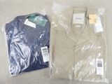 two shirts that are wrapped in plastic on a table