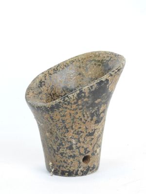 a small vase that is sitting on a white surface