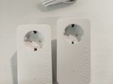two white power plugs sitting on a white table