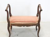an image of a bench with a pink cushion on top of it