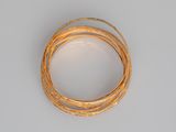gold plated wire on a white surface
