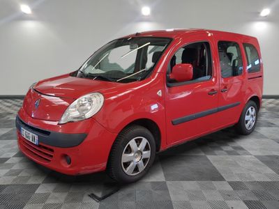 the small red van is parked in the garage on a checkered floor