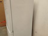 a white refrigerator sitting on a pallet in a warehouse