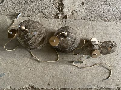 two balls of yarn on the ground next to a pair of shoes
