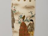 a vase with a painting on it sitting on a table