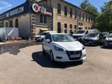 a white car parked in front of a building with cars parked in front of it