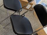 three chairs that are sitting on the floor next to a box