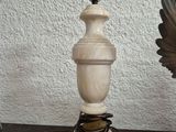 a lamp that is on a table with a bird next to it