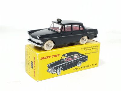 a black toy car sitting on top of a yellow box