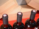 several bottles of wine are lined up on a red table