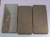 three iphones sitting on top of a table next to each other
