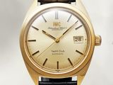 an image of a gold watch with a black leather strap