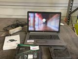 a laptop computer sitting on top of a wooden table