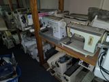 many sewing machines sitting on a shelf in a room