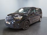 the black van is parked in a large room with a black floor
