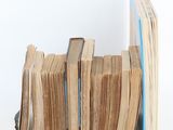 a lot of books stacked on top of each other