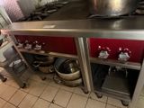 many pots and pans on the counter in the kitchen