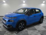 a blue citrole is parked in a large room