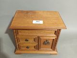 a small wooden table with three drawers on top of it