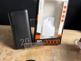 a box of power bank sitting on a table next to a pair of scissors