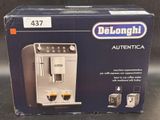 packaging of delonghi automatic coffee machine in box on table