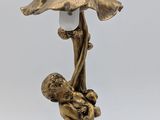 an image of a lamp with a statue of a woman holding a child