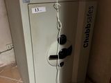a small refrigerator with a microwave on top of it