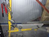 a yellow crane with a chain attached to it