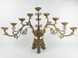 brass candelab with five arms and five flowers on each end