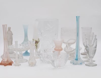 many different colored glass vases on a white surface