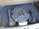 the inside of a car trunk with an open lid and a small device in it