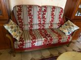 a red and white striped couch in a living room