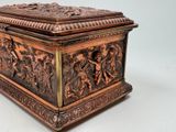 a wooden box with carvings on it sitting on a table