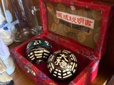 a red box with two black and white dices in it