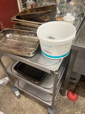 several pans of food are sitting on a table in a kitchen