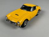 a yellow toy car that is sitting on a table