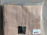 a close up of a bag of folded towels on a table