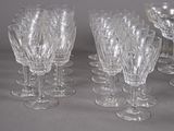 many wine glasses lined up on a table