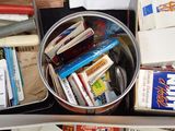 a lot of books in a metal container on a table