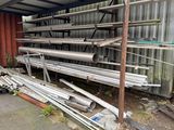 a pile of metal pipes sitting outside of a building