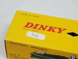 a box of dinky cars sitting on a white surface