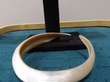 an image of a ring on a stand on a blue surface