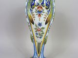 a vase that is sitting on a white surface