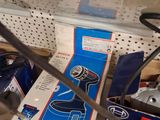 a box of tools sitting on a shelf next to a pair of scissors