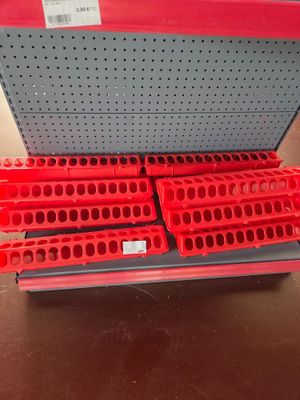 a close up of a shelf with a bunch of red bins on it