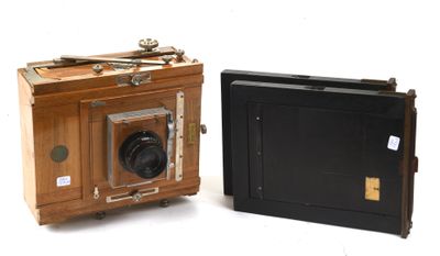 two old cameras sitting next to each other on a white surface