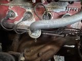 a close up of an old car engine with a hose