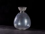 a clear glass vase with a clear top sitting on a black surface