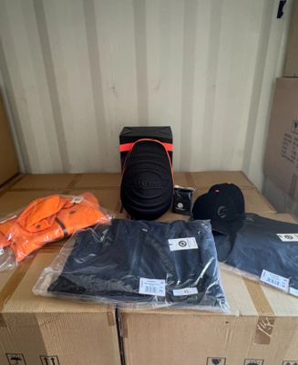 a box with a camera, a hat, and other items on it